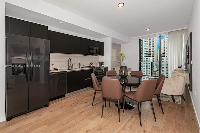 dining room with sink and light wood-type flooring