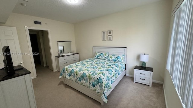 carpeted bedroom featuring a textured ceiling