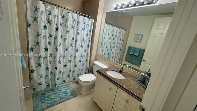 bathroom featuring vanity, toilet, a shower with curtain, and tile patterned floors