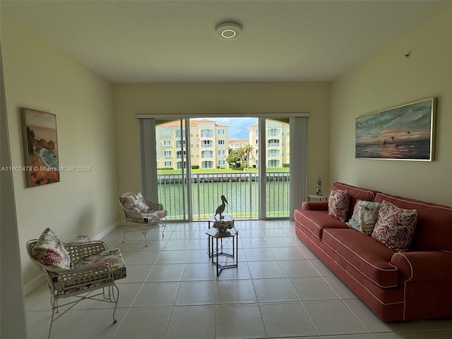 living room with a water view and light tile patterned flooring