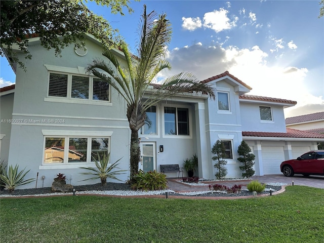 mediterranean / spanish home with a garage and a front yard