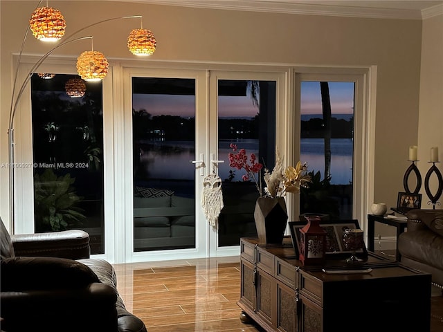 interior space with ornamental molding and hardwood / wood-style flooring