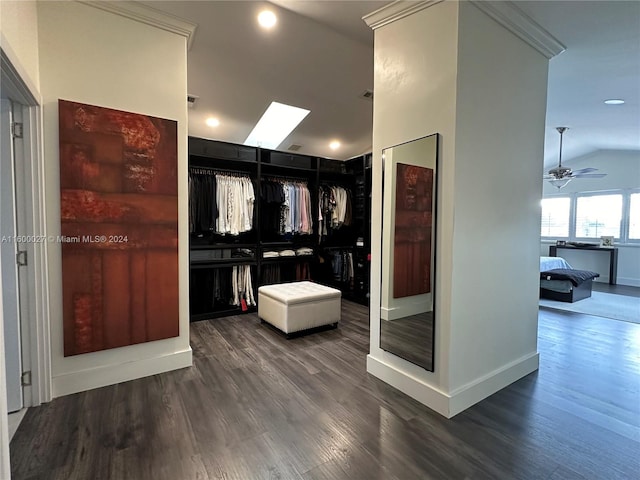 interior space with vaulted ceiling with skylight and dark hardwood / wood-style floors