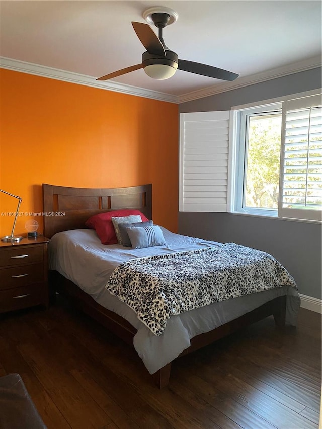 bedroom with dark wood-type flooring, ceiling fan, and crown molding