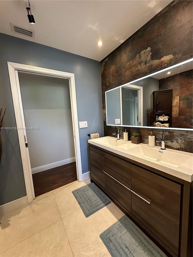 bathroom with dual sinks, hardwood / wood-style flooring, and large vanity