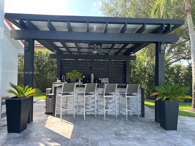 view of terrace featuring a pergola and an outdoor bar