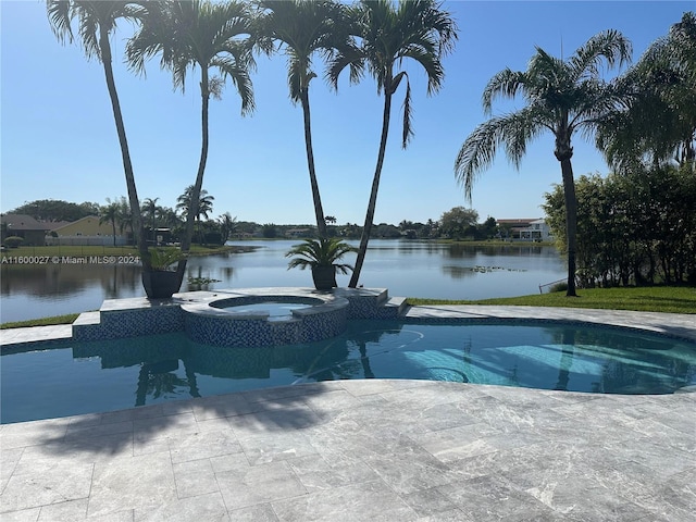 view of swimming pool with a patio, an in ground hot tub, and a water view