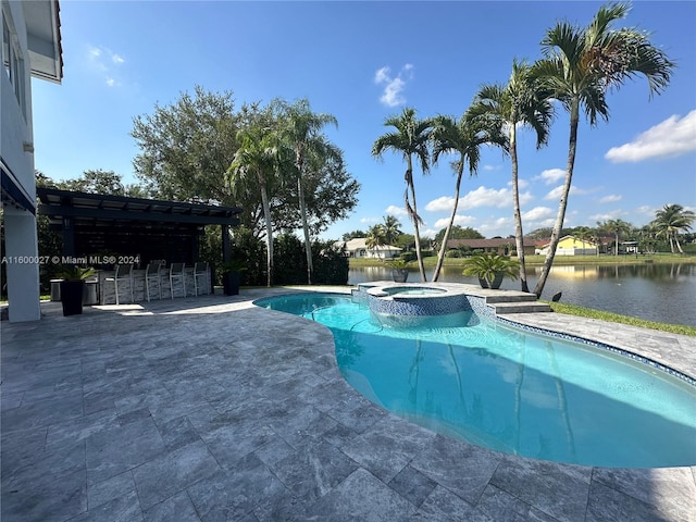 view of swimming pool with a patio area, a pergola, and an in ground hot tub