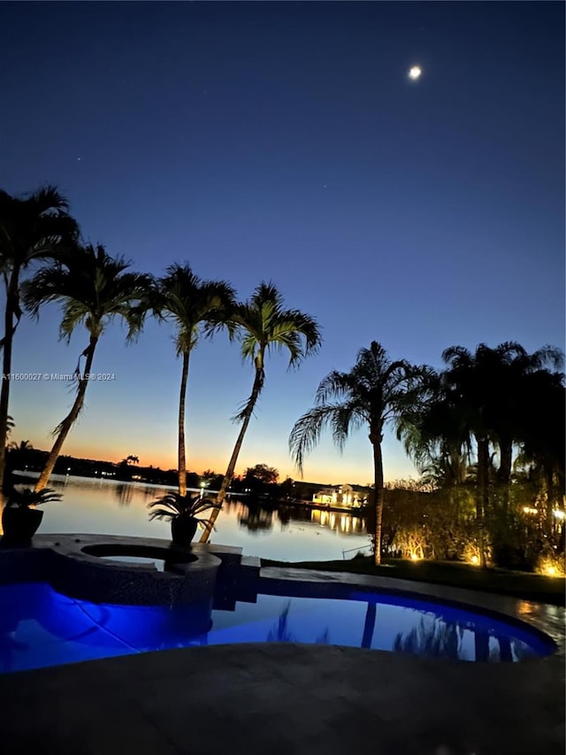 view of pool at dusk