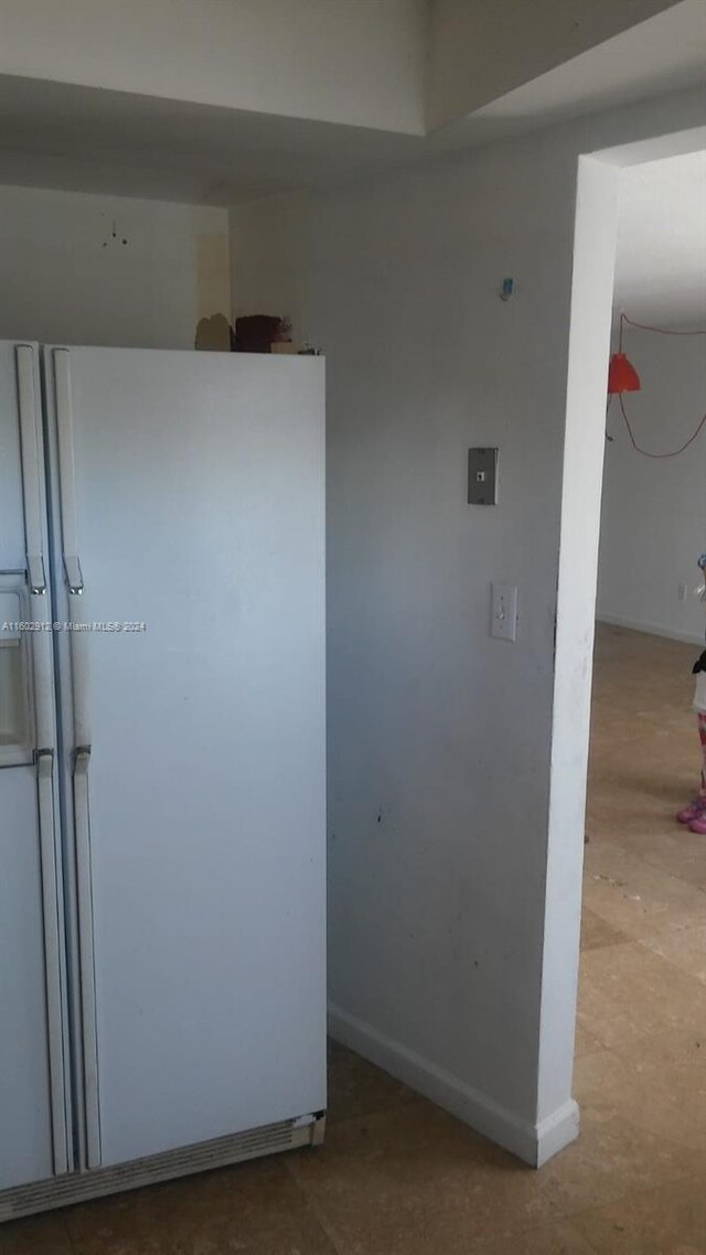 kitchen featuring white refrigerator with ice dispenser