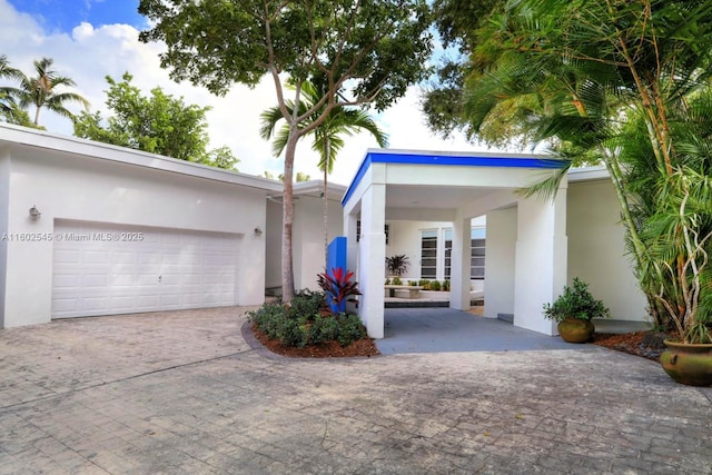 garage featuring decorative driveway