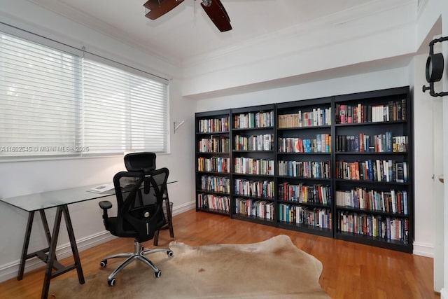 office area with baseboards, ceiling fan, wood finished floors, and crown molding