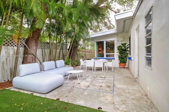 view of patio / terrace with an outdoor living space, outdoor dining area, and fence