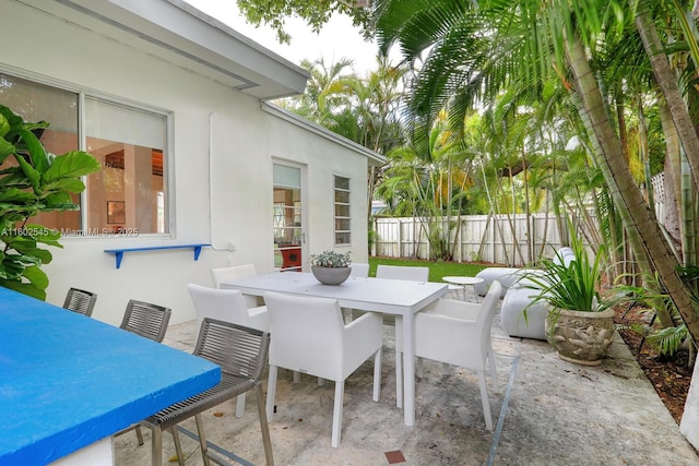 view of patio / terrace featuring fence and outdoor dining space
