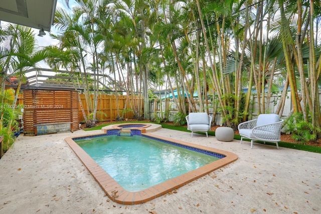 view of pool featuring an in ground hot tub and a patio