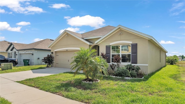 single story home with a garage and a front lawn