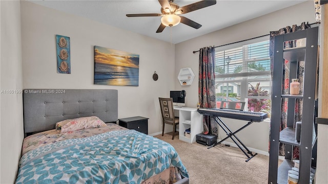 bedroom with ceiling fan and light carpet