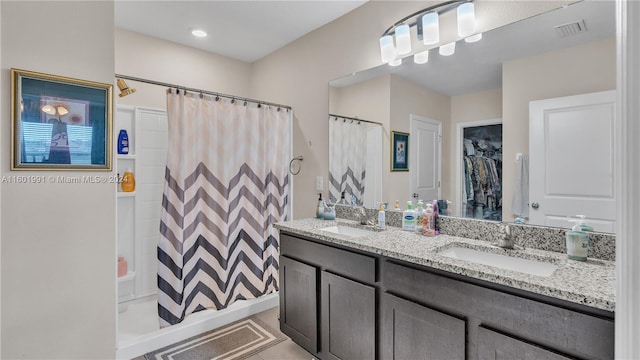 bathroom featuring vanity, curtained shower, and tile patterned flooring