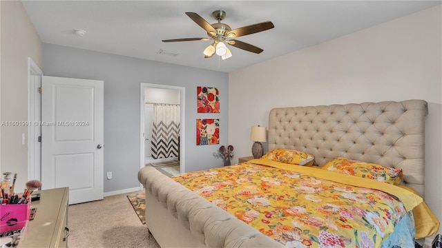 carpeted bedroom with ceiling fan and ensuite bath