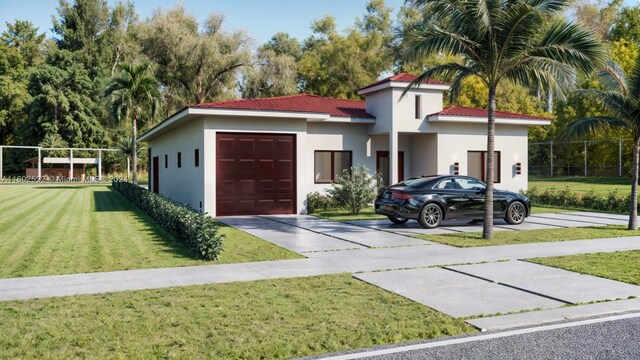 view of front of property featuring a garage and a front lawn