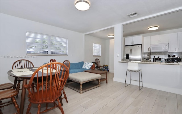 dining area with light hardwood / wood-style flooring