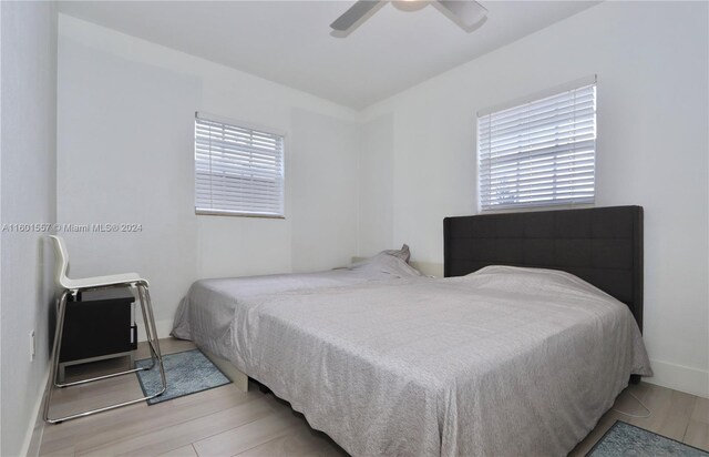 bedroom with ceiling fan and light hardwood / wood-style floors