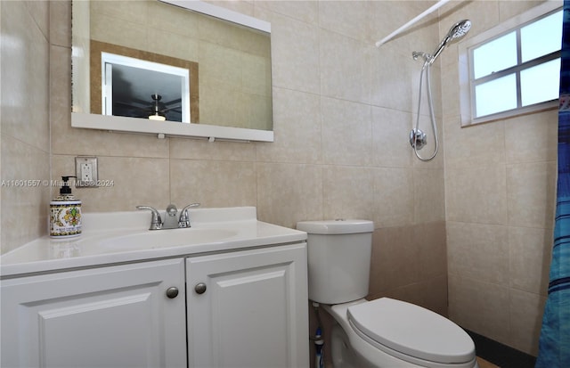 bathroom featuring vanity, tile walls, a shower with shower curtain, and toilet