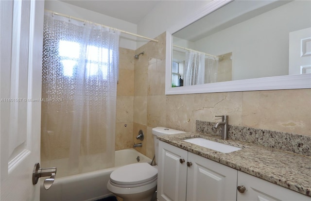 full bathroom with tile walls, backsplash, vanity, toilet, and shower / bath combo with shower curtain