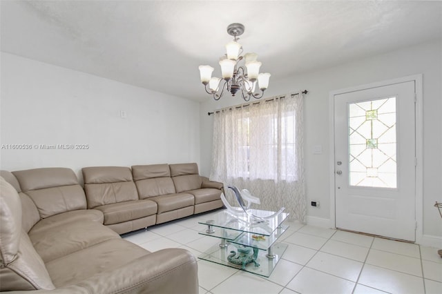 living area featuring baseboards, an inviting chandelier, and light tile patterned flooring