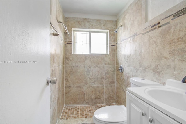 full bath featuring toilet, a shower stall, and vanity