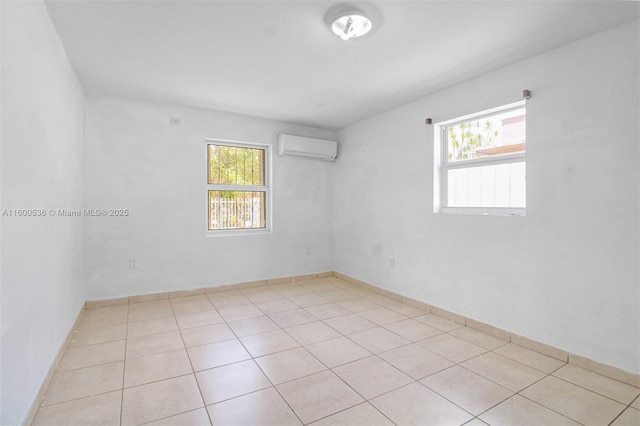 empty room featuring light tile patterned floors and a wall mounted AC