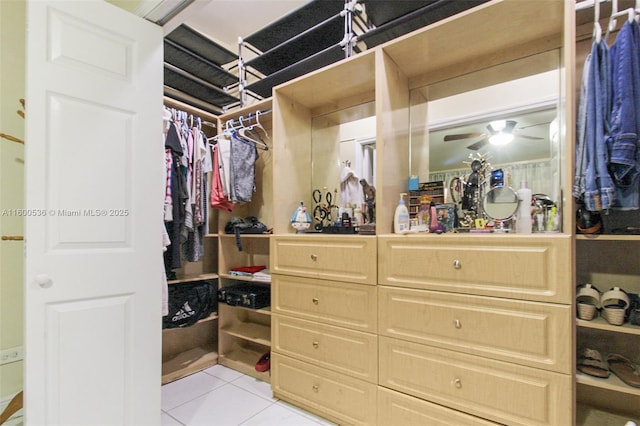 walk in closet with light tile patterned floors and ceiling fan