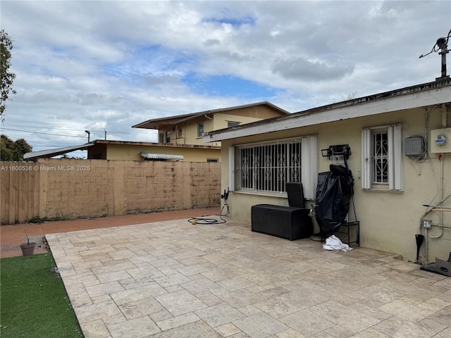 view of patio featuring fence