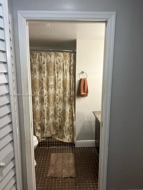 bathroom with vanity, toilet, and curtained shower