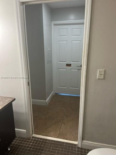 bathroom with tile patterned floors, vanity, and toilet