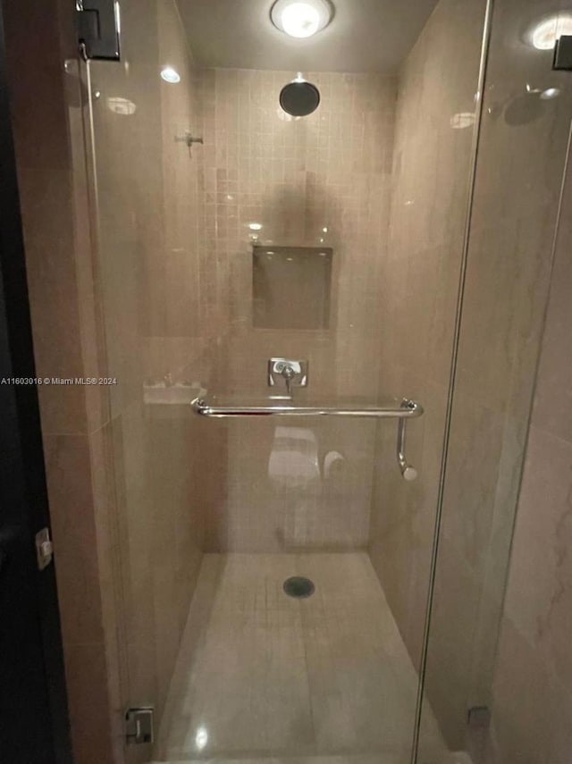 bathroom with a shower with shower door