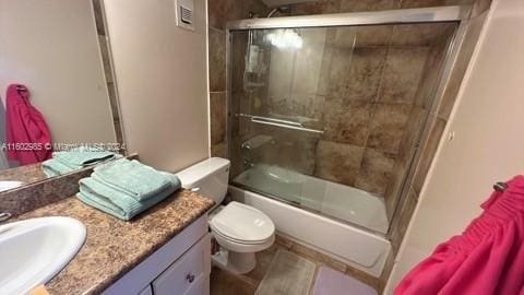 full bathroom with vanity, toilet, and combined bath / shower with glass door