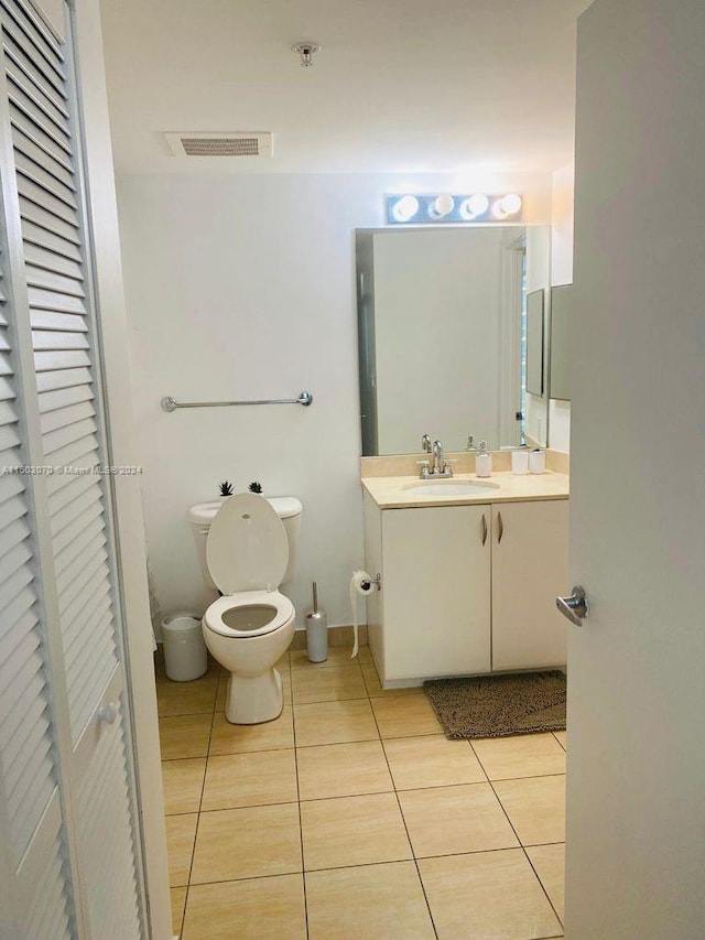 bathroom featuring tile patterned floors, vanity, visible vents, and toilet