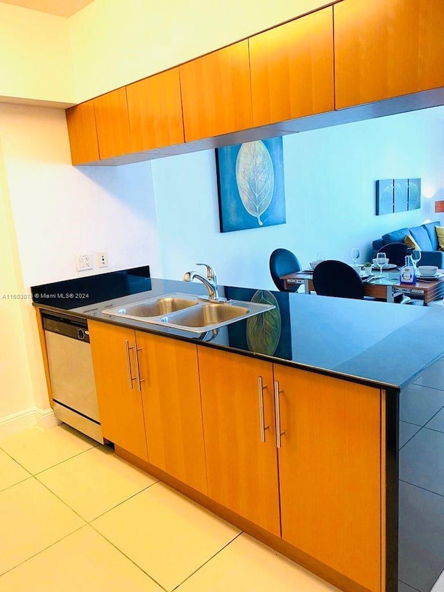 kitchen with sink, white dishwasher, and light tile floors