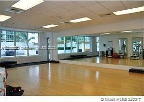 workout area featuring a drop ceiling and wood finished floors