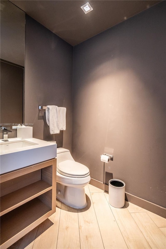 bathroom featuring vanity, toilet, and hardwood / wood-style floors