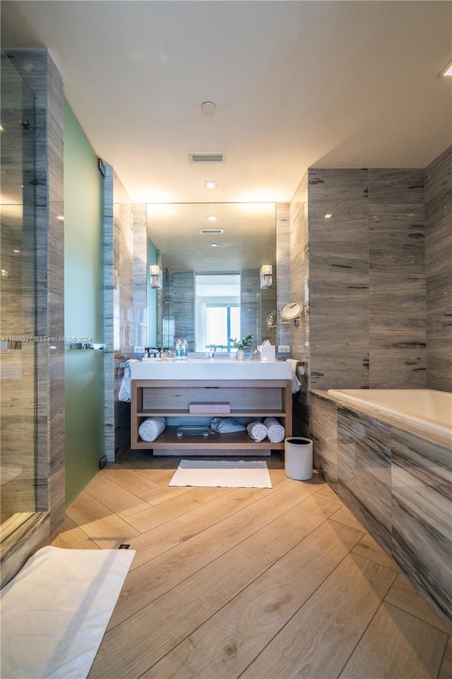 bathroom with vanity, wood-type flooring, and walk in shower