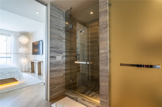 bathroom featuring an enclosed shower and parquet flooring