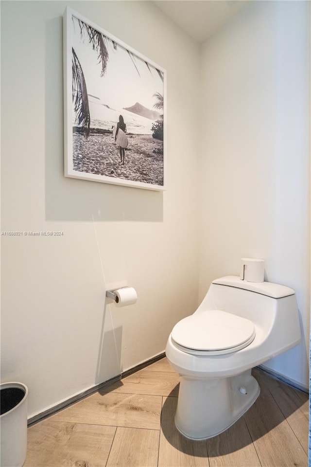 bathroom featuring hardwood / wood-style floors and toilet