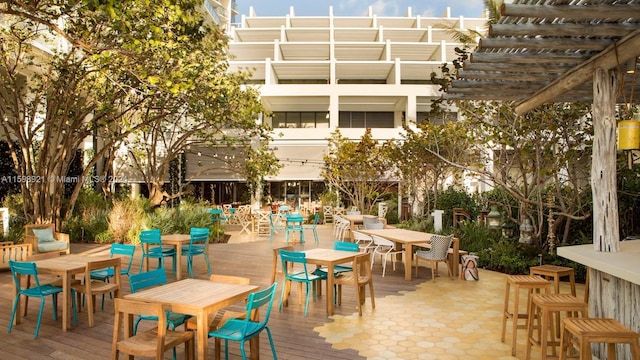 exterior space with a wooden deck and a pergola