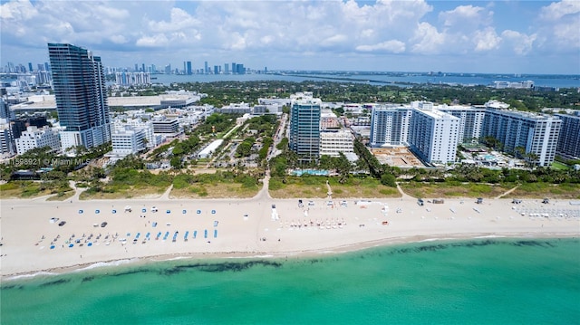 aerial view with a water view and a beach view