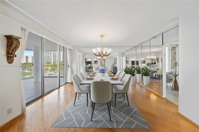 dining space featuring light hardwood / wood-style floors and an inviting chandelier