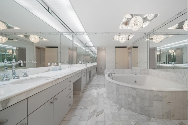 bathroom with vanity and tiled bath