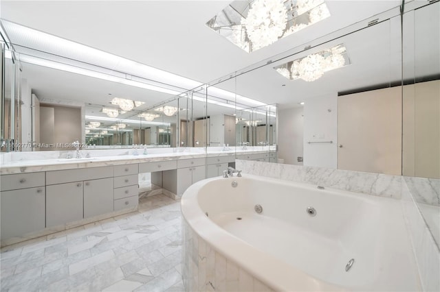 bathroom with vanity and a relaxing tiled tub