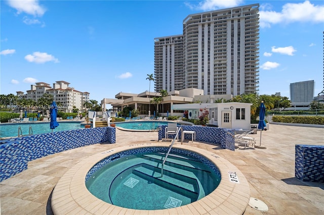 view of pool featuring a patio and a hot tub